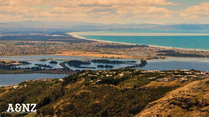 Aerial view over town of Christchurch from hills to ocean